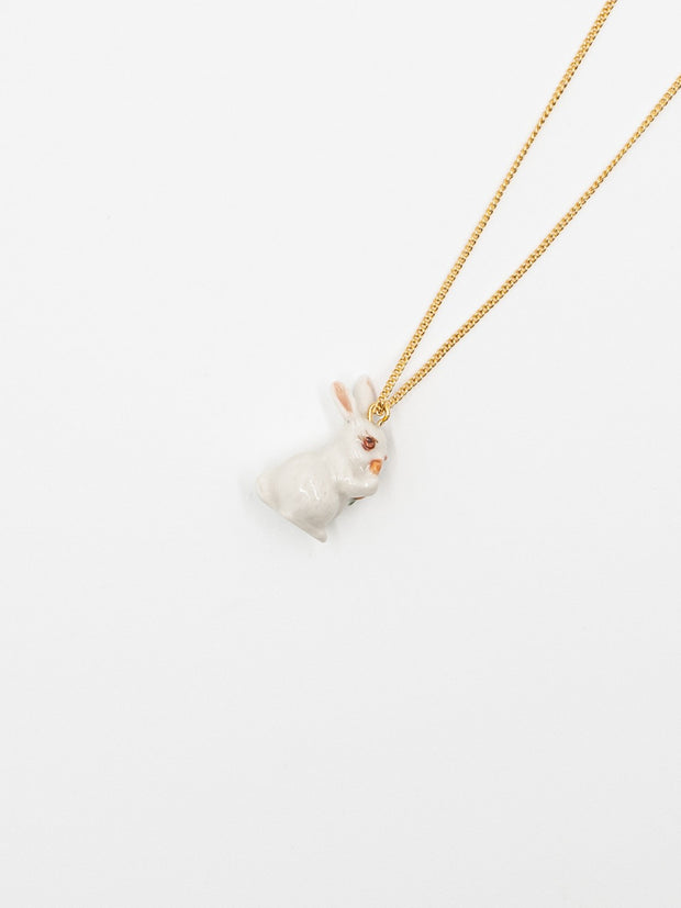 white rabbit with carrot necklace