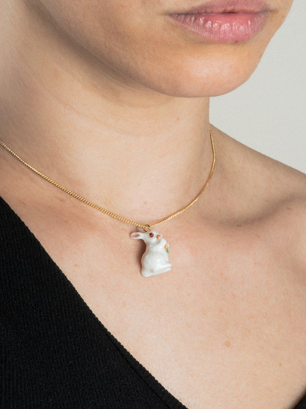 white rabbit with carrot necklace